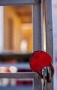 close-up of a heart-shaped iron padlock on a lattice door