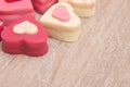 Close up of heart shaped petit fours cakes on a wooden background Royalty Free Stock Photo