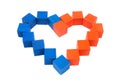 Close-up of a heart symbol made of red and blue wooden cubes on a white background. Top view, selective focus. Royalty Free Stock Photo