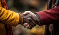 Close-up of a heartfelt handshake between two people showcasing a multicultural bond of respect and friendship