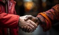 Close-up of a heartfelt handshake between two people showcasing a multicultural bond of respect and friendship