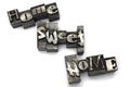 Closeup lead letters home sweet white background