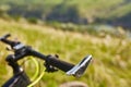 Close-up of helm of the mountain bicycle in the green grass against beautiful landscape.