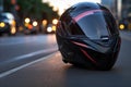 close-up of a helmet on asphalt, with blurred headlights in the background