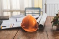 Close up of helmet with blueprint and etc. on architect desk, architectural concept Royalty Free Stock Photo