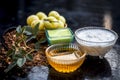 Close up of herbal face pack of Indian gooseberry or amla with curd or yogurt and honey in a glass bowl on wooden surface used to