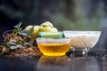 Close up of herbal face pack of Indian gooseberry or amla with curd or yogurt and honey in a glass bowl on wooden surface used to