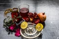 Close up of herbal face pack of pomegranate and lemon juice with rose water on wooden surface with some sliced lemons and pomegran Royalty Free Stock Photo