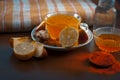 Close up of a herbal tea  consisting of apple juice,lemon,ginger and warm water in a transparent cup on a wooden surface in dark G Royalty Free Stock Photo