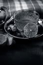 Close up of a herbal tea  consisting of apple juice,lemon,ginger and warm water in a transparent cup on a wooden surface in dark G Royalty Free Stock Photo