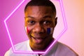 Close-up of hexagon neon over happy african american fan with france flag on cheek during match Royalty Free Stock Photo