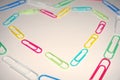 Colorful Paper Clips Forming a Heart Shape on a White Surface Royalty Free Stock Photo