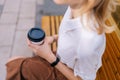 Close-up high-angle view cropped shot of unrecognizable elegant woman holding in hands paper cup with takeaway coffee. Royalty Free Stock Photo