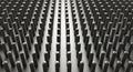 Abstract pattern of numerous dark gray cylindrical pins arranged in a grid formation arrangement Royalty Free Stock Photo
