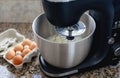 Close up high angle view of electric modern mixer creaming cake dough