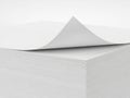 Stack of white paper with curled top sheet isolated on white background Royalty Free Stock Photo