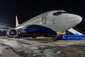 Close-up with high detail of a large wide-body passenger aircraft standing in the airport parking lot during ground handling at Royalty Free Stock Photo