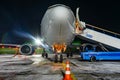 Close-up with high detail of a large wide-body passenger aircraft standing in the airport parking lot during ground handling at Royalty Free Stock Photo