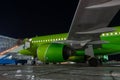 Close-up with high detail of a large wide-body passenger aircraft standing in the airport parking lot during ground handling at Royalty Free Stock Photo