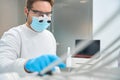 Close-up high-qualified dental technician in uniform and special magnifying glasses Royalty Free Stock Photo