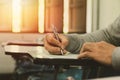 Close up , High School male student holding pencil exams writing in classroom for education test ,Copy space for your text Royalty Free Stock Photo