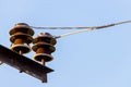 Close up of high voltage insulators with aluminium wire at power-tower Royalty Free Stock Photo