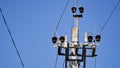 Close-up high voltage power line on a background of blue sky on a sunny day. Electro pole, pole with wires, live wires, Royalty Free Stock Photo