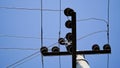 Close-up high voltage power line on a background of blue sky on a sunny day. Electro pole, pole with wires, live wires, Royalty Free Stock Photo