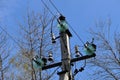 Close-up of high-voltage power lines and power pylons against a blue sky. Royalty Free Stock Photo