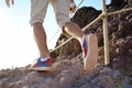 Close-up of hiker legs trekking along a rocky path