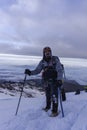 Close up hiker portrait on snowfield and mountain background