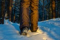 Close up of hiker shoes walking on the snow in the forest. Exploring woodland in winter time Royalty Free Stock Photo