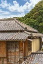 Hip roof ornate with decorative Onigawara tile at the end of the ridge of a Japanese ryokan.