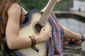 Close up. hippie woman playing guitar near forest lake Royalty Free Stock Photo