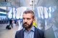 Close up of hipster businessman with earphones, subway station Royalty Free Stock Photo