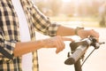 Close up of hipster man turns on the electric scooter. Male is pushing start button of modern gadget and driving along Royalty Free Stock Photo