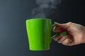 close up of hipster young woman hand handle with Steaming of green coffee mug.