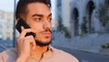 Close-up hispanic emotional business man bearded serious guy talking on mobile phone answering call using smartphone Royalty Free Stock Photo