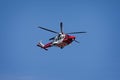 Close up of HM Coastguard rescue helicopter flying overhead at Beer, Devon, UK