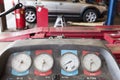 Close-up of a hoist pressure gauge in garage