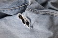 Close up of hole in an old pair of blue jeans Royalty Free Stock Photo