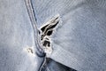 Close up of hole in an old pair of blue jeans Royalty Free Stock Photo