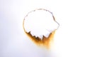 hole paper with edges burned on white background Royalty Free Stock Photo