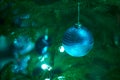 Close up of holiday electric blue garlands on fir branch with Christmas tree decoration and candy cane Royalty Free Stock Photo