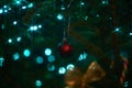 Close up of holiday electric blue garlands on fir branch with Christmas tree decoration and candy cane Royalty Free Stock Photo