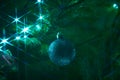 Close up of holiday electric blue garlands on fir branch with Christmas tree decoration and candy cane Royalty Free Stock Photo