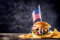 Close-up home made beef burger with american flag and fries on w Royalty Free Stock Photo