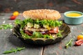 Close-up of home made hamburger with feta cheese and chicken beef on a wooden table. symbol of diet temptation resulting in Royalty Free Stock Photo