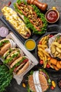 Close-up of home made tasty burger and hot dogs with fried chicken french fries. raditional American food. fast food Royalty Free Stock Photo