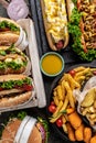 Close-up of home made tasty burger and hot dogs with fried chicken french fries. raditional American food. fast food. vertical Royalty Free Stock Photo